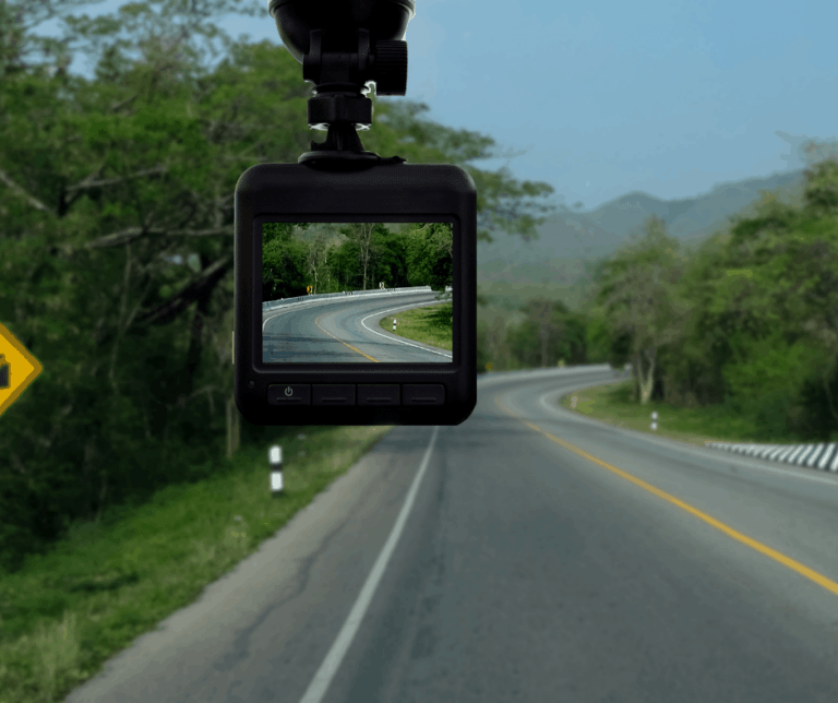 A road sign captured by a dash cam in the background.