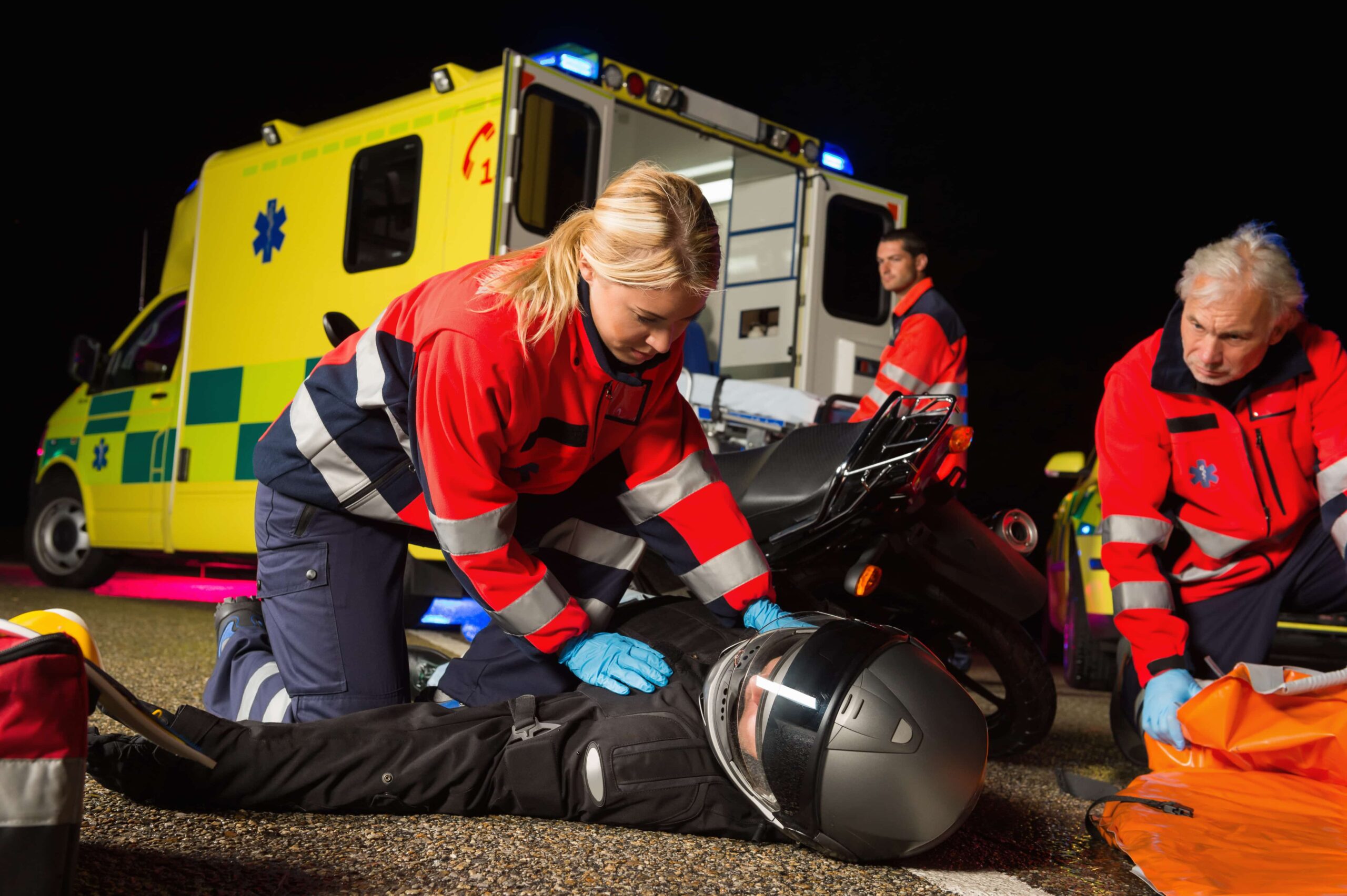 A patient in need of medical attention after a slip and fall incident, spotted beside the road with an ambulance nearby.