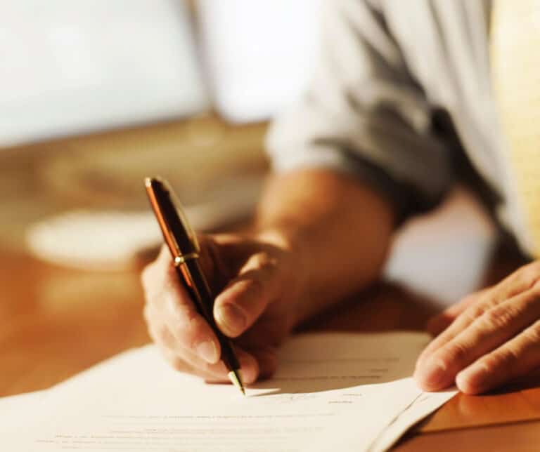 A man signing an enforceable waiver document.